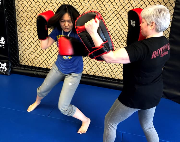 a woman hitting targets with boxing gloves