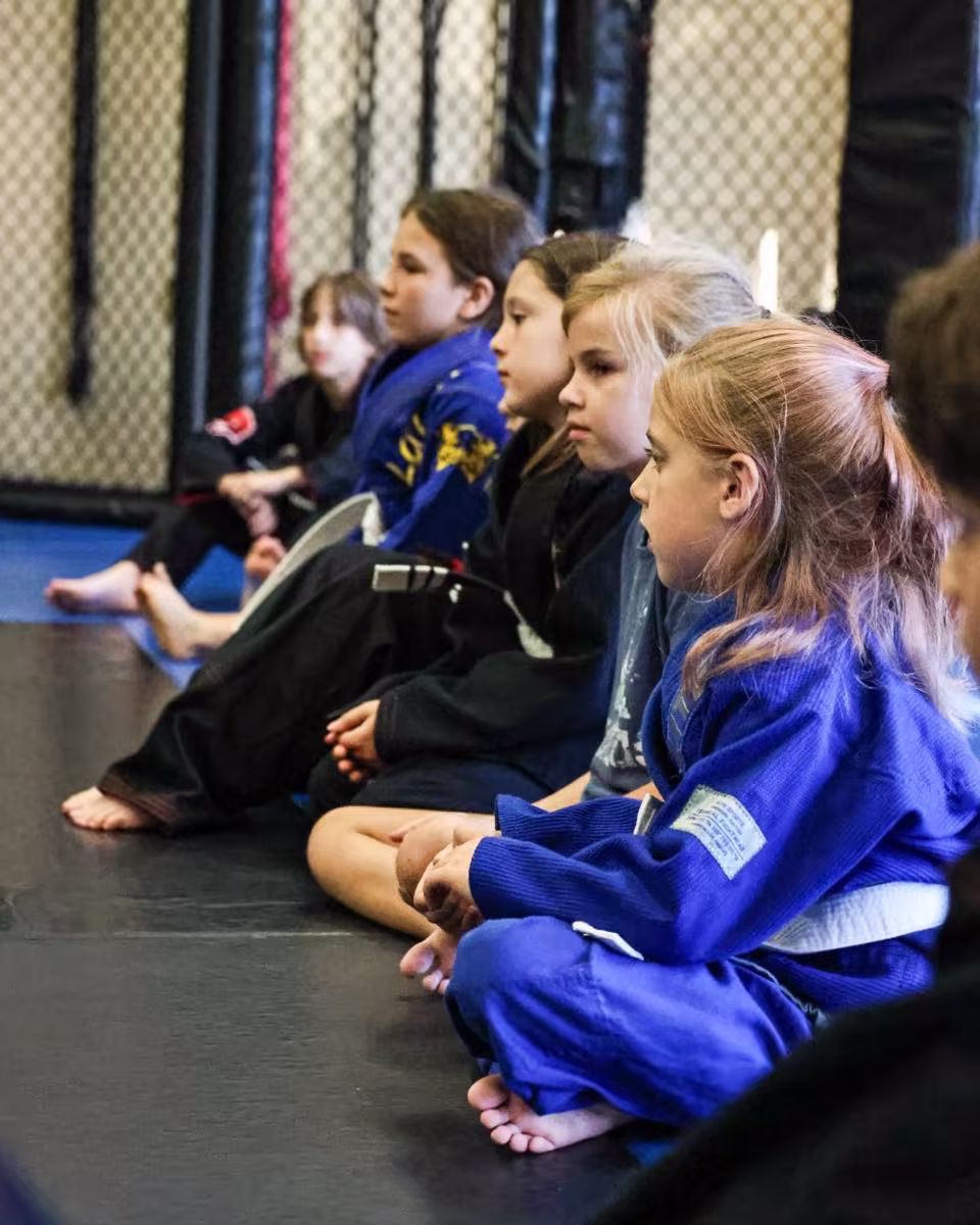 children sitting and listening to instruction
